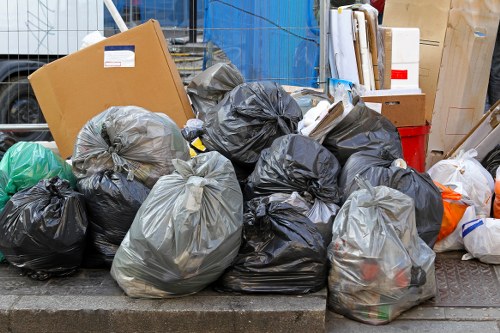 Workers carrying reusable furniture for charity pickup during a clearance